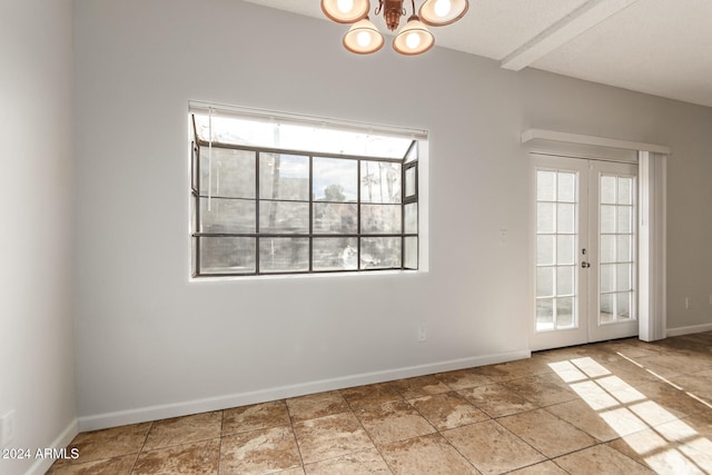 empty room featuring french doors, a notable chandelier, and beam ceiling