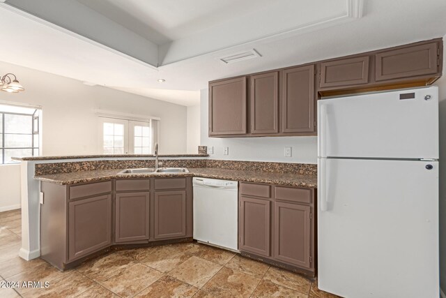 kitchen featuring kitchen peninsula, white appliances, sink, and french doors