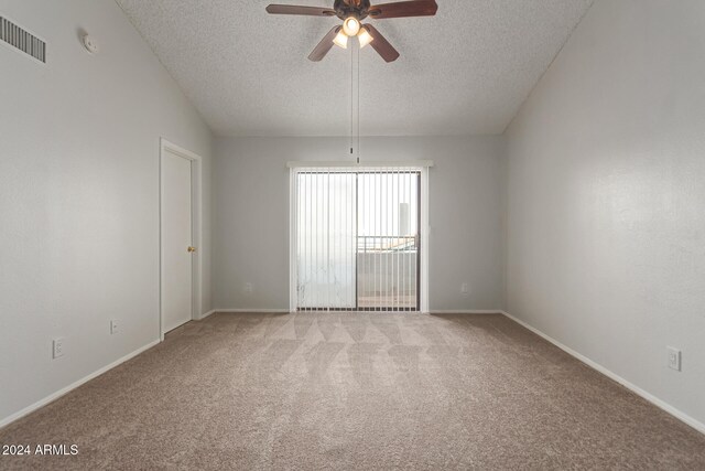 spare room with ceiling fan, a textured ceiling, and carpet floors