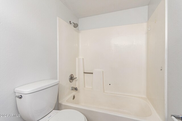 bathroom with toilet and bathing tub / shower combination