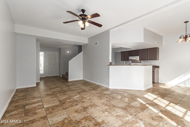 unfurnished living room with a textured ceiling and ceiling fan with notable chandelier