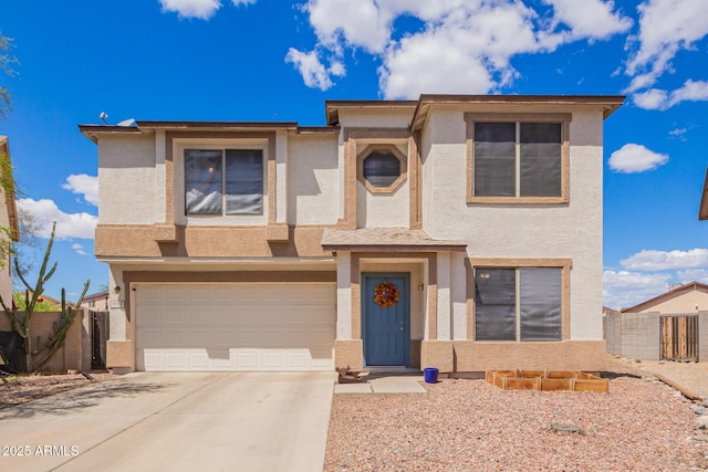 view of front facade with fence, driveway, stucco siding, and an attached garage