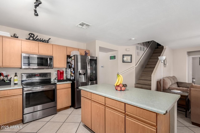 kitchen featuring light tile patterned flooring, light countertops, visible vents, stainless steel appliances, and open floor plan