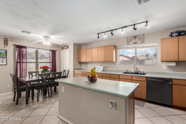 kitchen with light countertops, a sink, ceiling fan, dishwasher, and visible vents