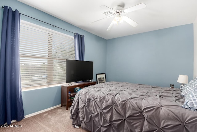 carpeted bedroom featuring baseboards and ceiling fan