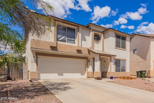 view of front facade featuring stucco siding, driveway, a garage, and fence