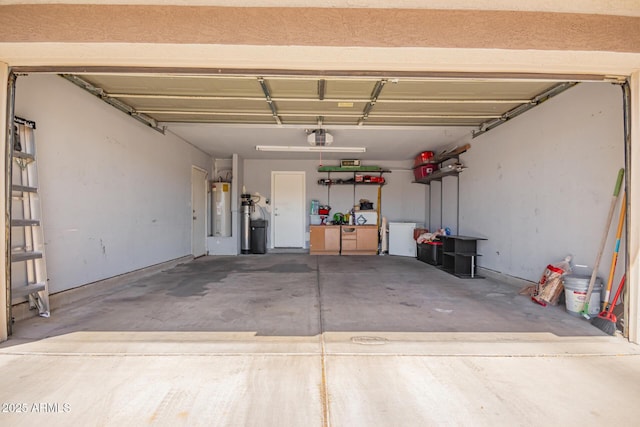 garage with a garage door opener and electric water heater