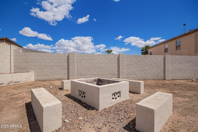 exterior space with a fire pit and a fenced backyard