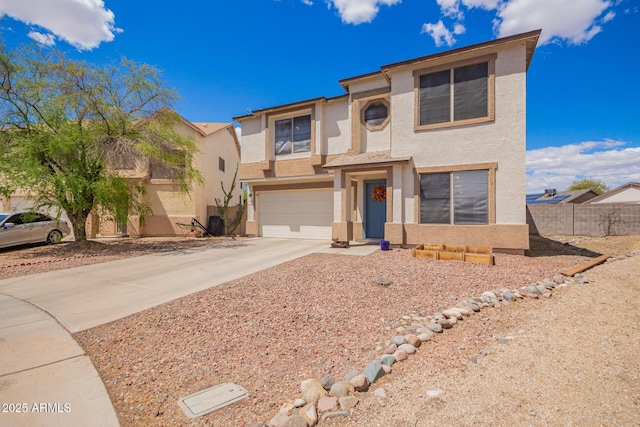 view of front of home featuring stucco siding, a garage, concrete driveway, and fence