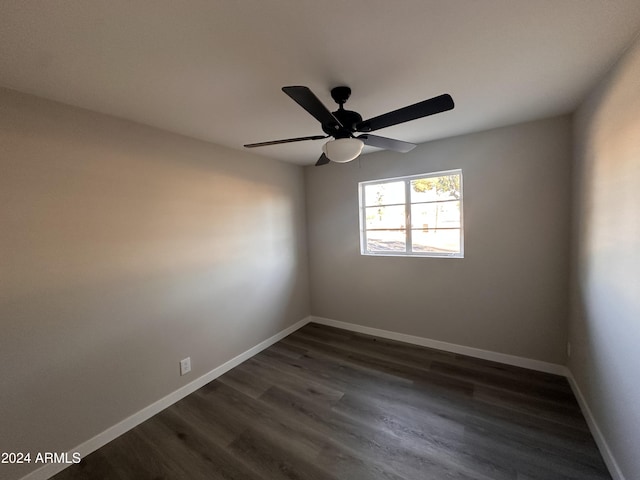 empty room with dark hardwood / wood-style floors and ceiling fan