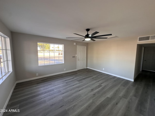 spare room featuring ceiling fan and dark hardwood / wood-style flooring