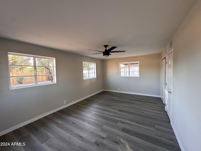 spare room featuring dark hardwood / wood-style flooring and ceiling fan