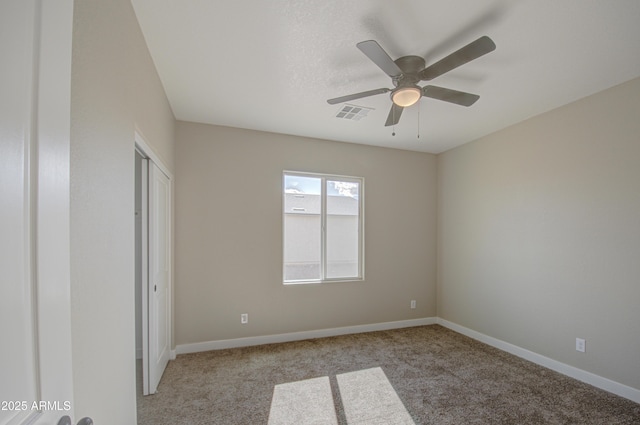 unfurnished bedroom with ceiling fan and light colored carpet