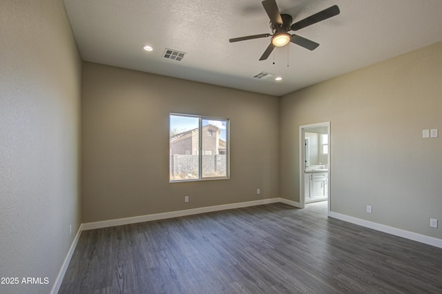 unfurnished room with ceiling fan, dark hardwood / wood-style floors, and a textured ceiling