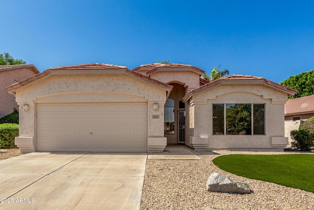 6502 W Wahalla Ln, Glendale, AZ 85308 - mediterranean / spanish home featuring a garage, driveway, stucco siding, and a tiled roof