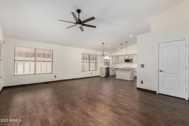 6502 W Wahalla Ln, Glendale, AZ 85308 - unfurnished living room with ceiling fan, a chandelier, dark wood-style flooring, high vaulted ceiling, and recessed lighting