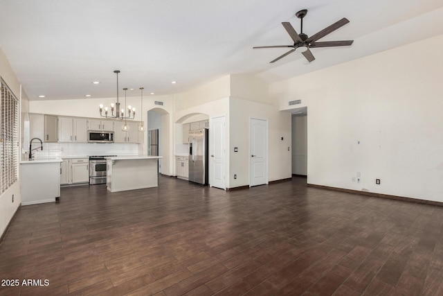 6502 W Wahalla Ln, Glendale, AZ 85308 - unfurnished living room with ceiling fan, a chandelier, arched walkways, dark wood finished floors, and recessed lighting