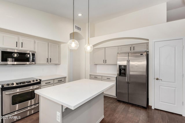 6502 W Wahalla Ln, Glendale, AZ 85308 - kitchen with appliances with stainless steel finishes, light countertops, tasteful backsplash, dark wood-style flooring, and recessed lighting