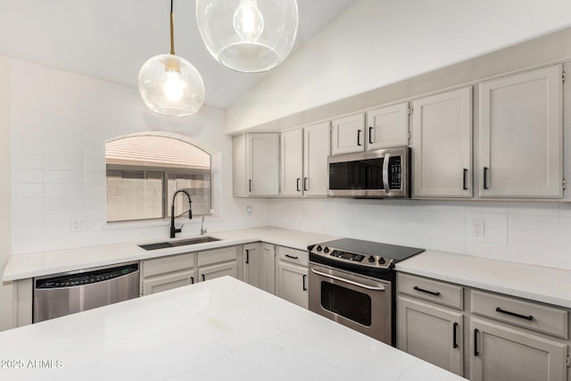 6502 W Wahalla Ln, Glendale, AZ 85308 - kitchen with stainless steel appliances, decorative backsplash, lofted ceiling, pendant lighting, and light stone countertops
