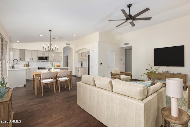 6502 W Wahalla Ln, Glendale, AZ 85308 - living area with vaulted ceiling, arched walkways, ceiling fan, a chandelier, and dark wood finished floors