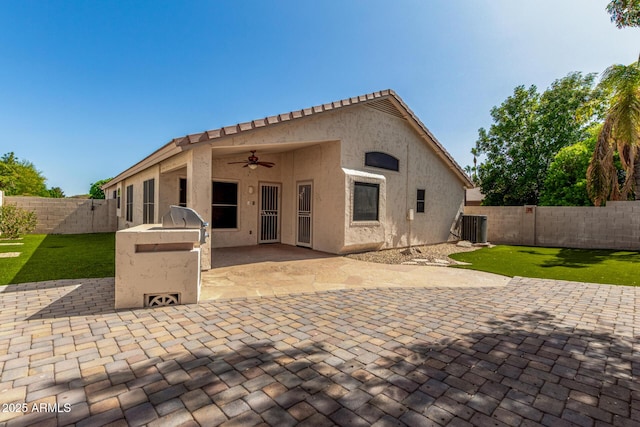 6502 W Wahalla Ln, Glendale, AZ 85308 - back of property with an outdoor kitchen, ceiling fan, a fenced backyard, a patio area, and stucco siding