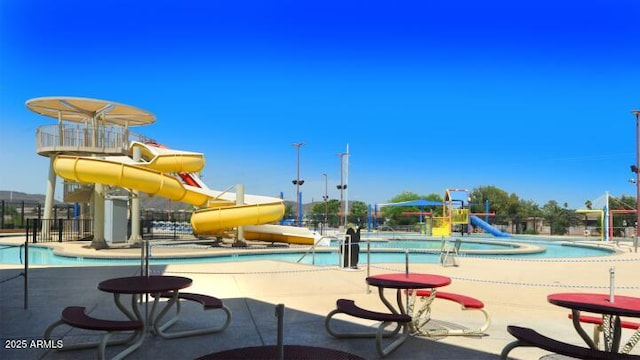 6502 W Wahalla Ln, Glendale, AZ 85308 - view of play area featuring a water play area, a community pool, and a patio area