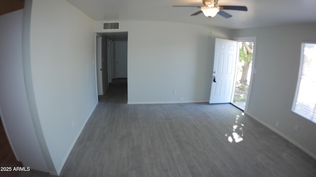 unfurnished room with dark hardwood / wood-style floors and ceiling fan