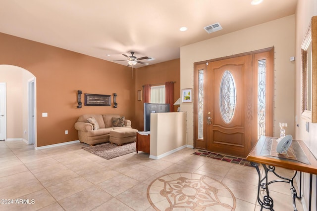 tiled foyer with ceiling fan