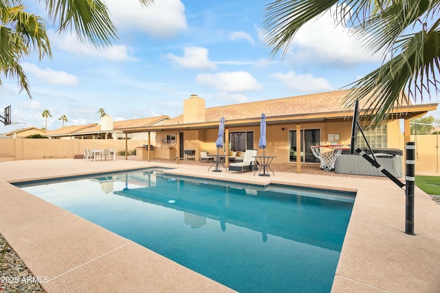 view of pool featuring a patio area and a hot tub