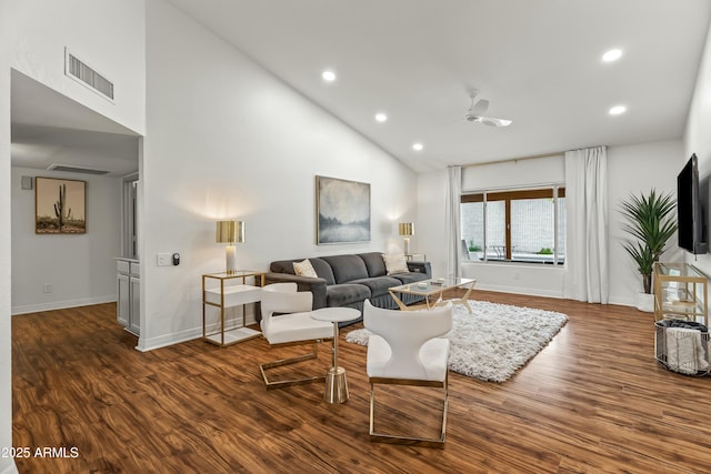 living room featuring ceiling fan, dark hardwood / wood-style flooring, and high vaulted ceiling