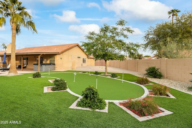 view of yard with a patio area and a hot tub