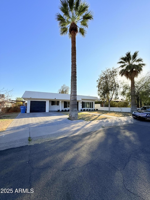 view of front facade featuring concrete driveway and an attached garage