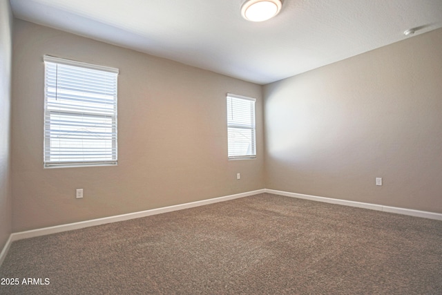 spare room with carpet floors and baseboards