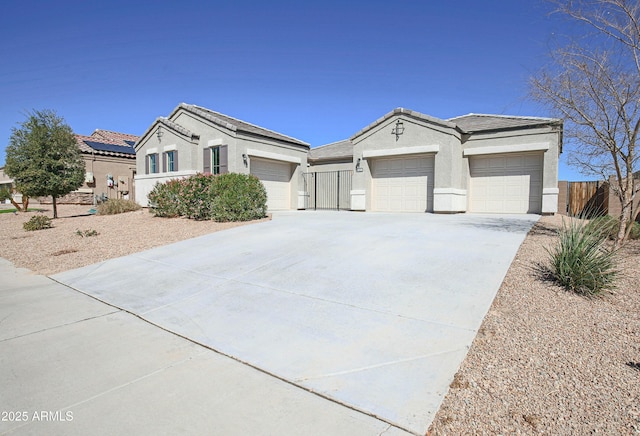 ranch-style house featuring a garage, concrete driveway, and stucco siding