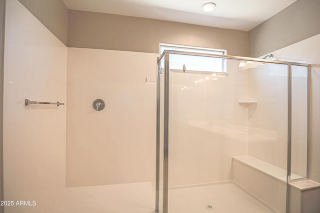 bathroom with a shower with door