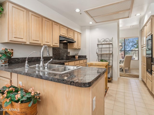 kitchen featuring kitchen peninsula and light brown cabinets