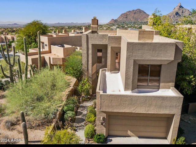 view of front of house with a mountain view and a garage