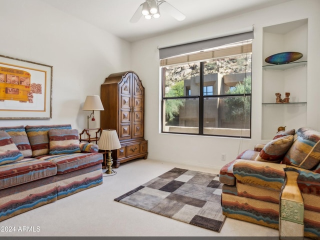 carpeted living room with ceiling fan