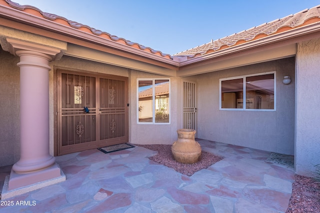 property entrance with a patio area