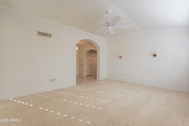 carpeted empty room with lofted ceiling, ceiling fan, and crown molding