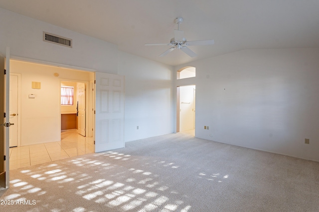 carpeted spare room with lofted ceiling and ceiling fan