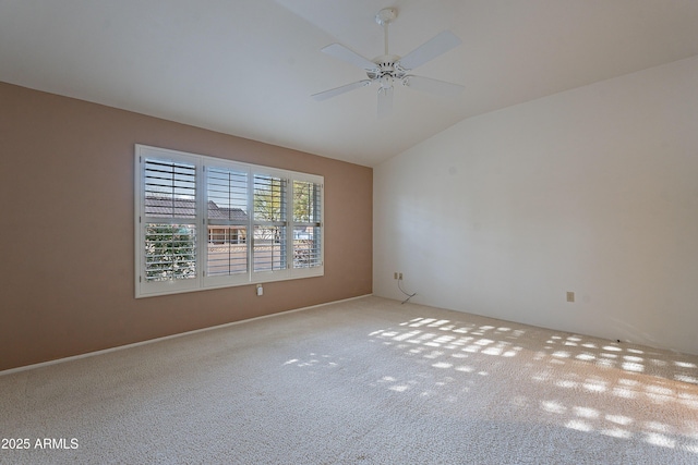 carpeted spare room with lofted ceiling and ceiling fan