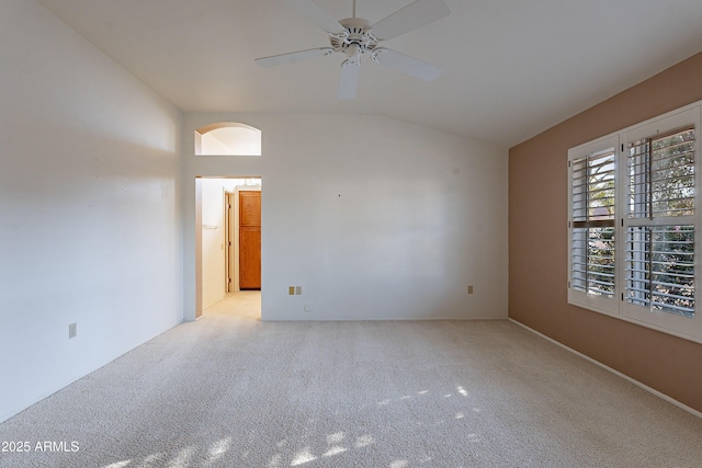 unfurnished room featuring ceiling fan, light carpet, and lofted ceiling