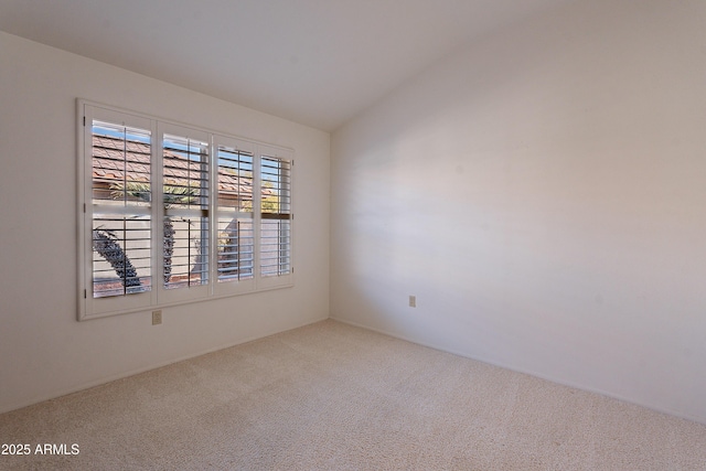 empty room with vaulted ceiling and carpet