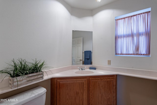 bathroom with toilet and vanity