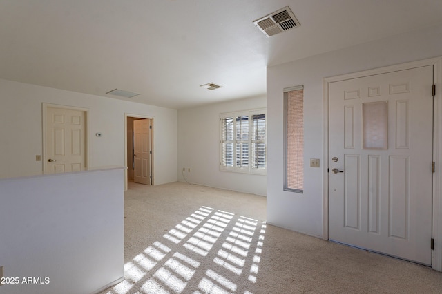 entrance foyer featuring light carpet