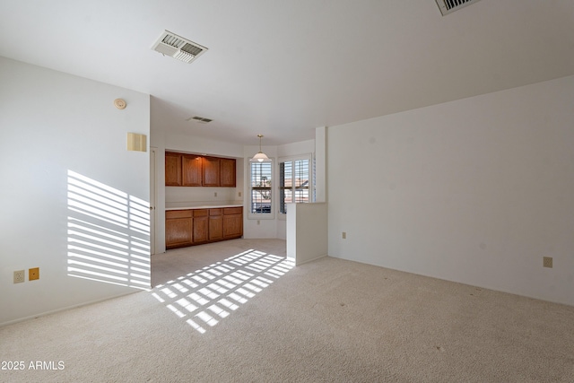 unfurnished living room featuring light colored carpet