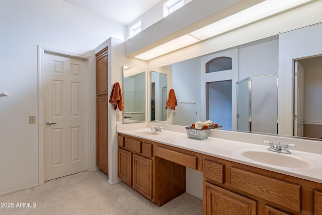 bathroom with a shower with door and vanity