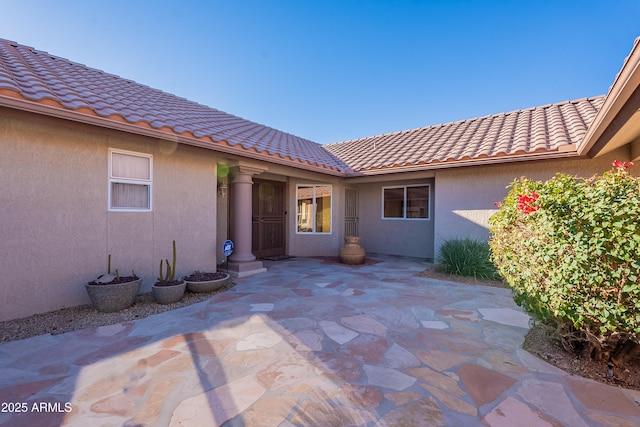 entrance to property featuring a patio