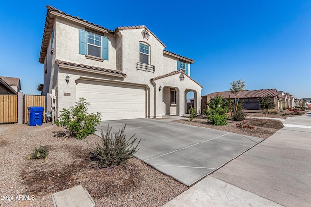 mediterranean / spanish-style home with a garage